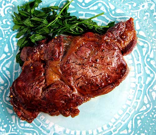 Seared steak in a cast iron pan.